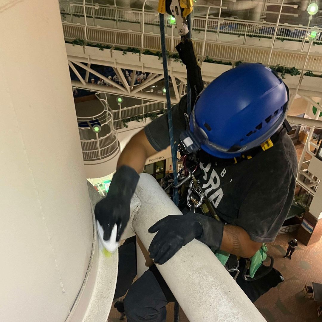 high level dusting crew cleaning high-rise interior pillar edmonton airport
