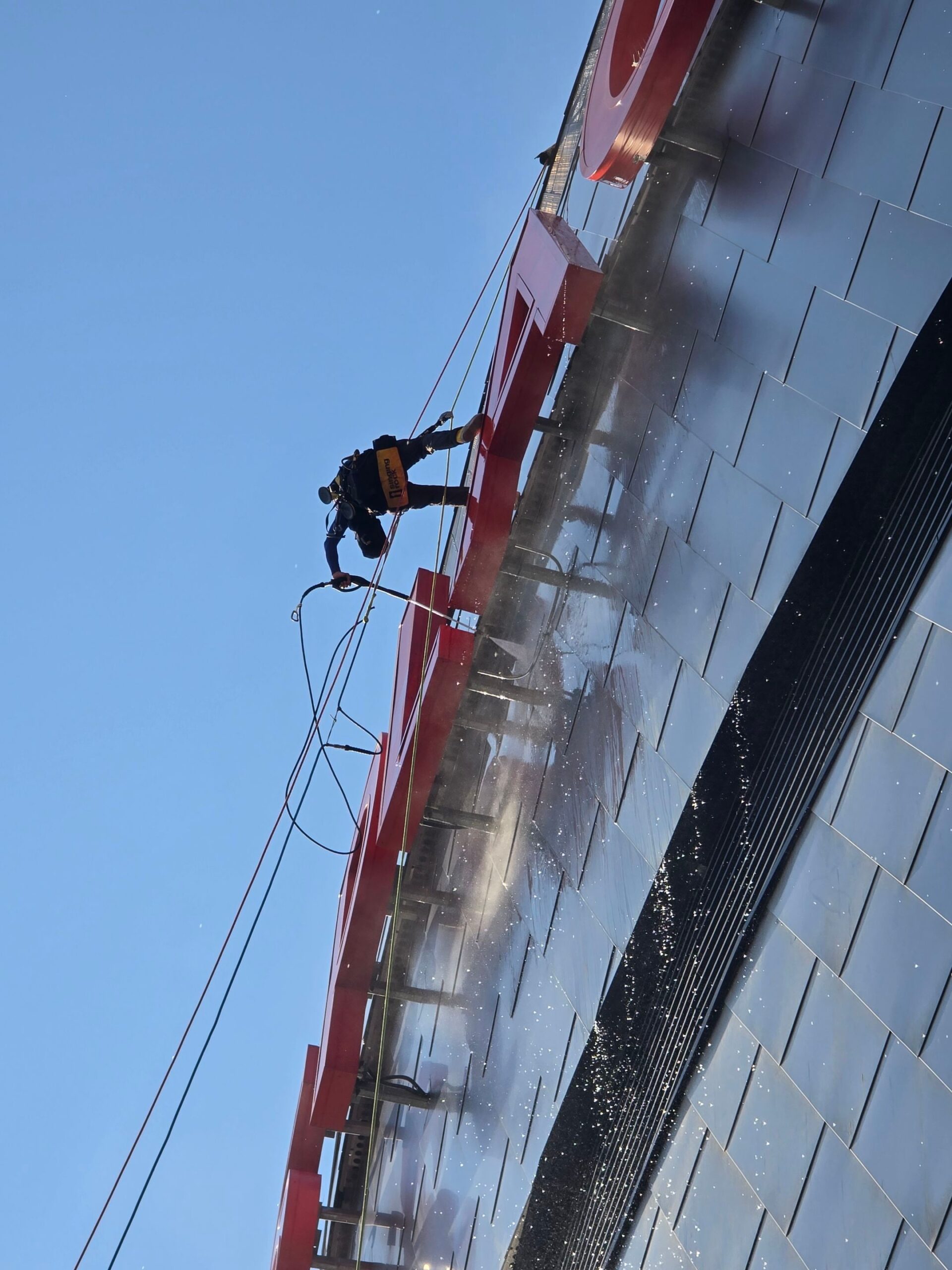 aurora industries pressure washing the rogers arena signage in downtown edmonton ice district